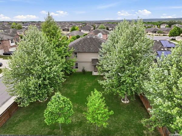 an aerial view of a house with a yard