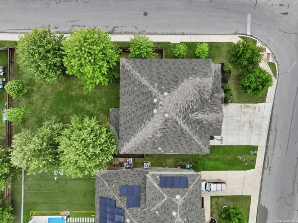 an aerial view of multiple houses with yard