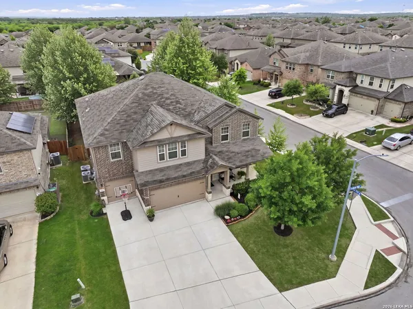 an aerial view of multiple houses with yard
