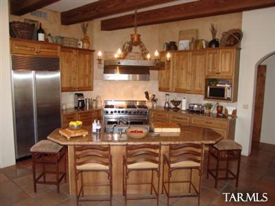 12222 Cloud Ridge Drive Tucson, AZ 85755 - Photo 4 of 10 a kitchen with stainless steel appliances granite countertop a refrigerator and microwave