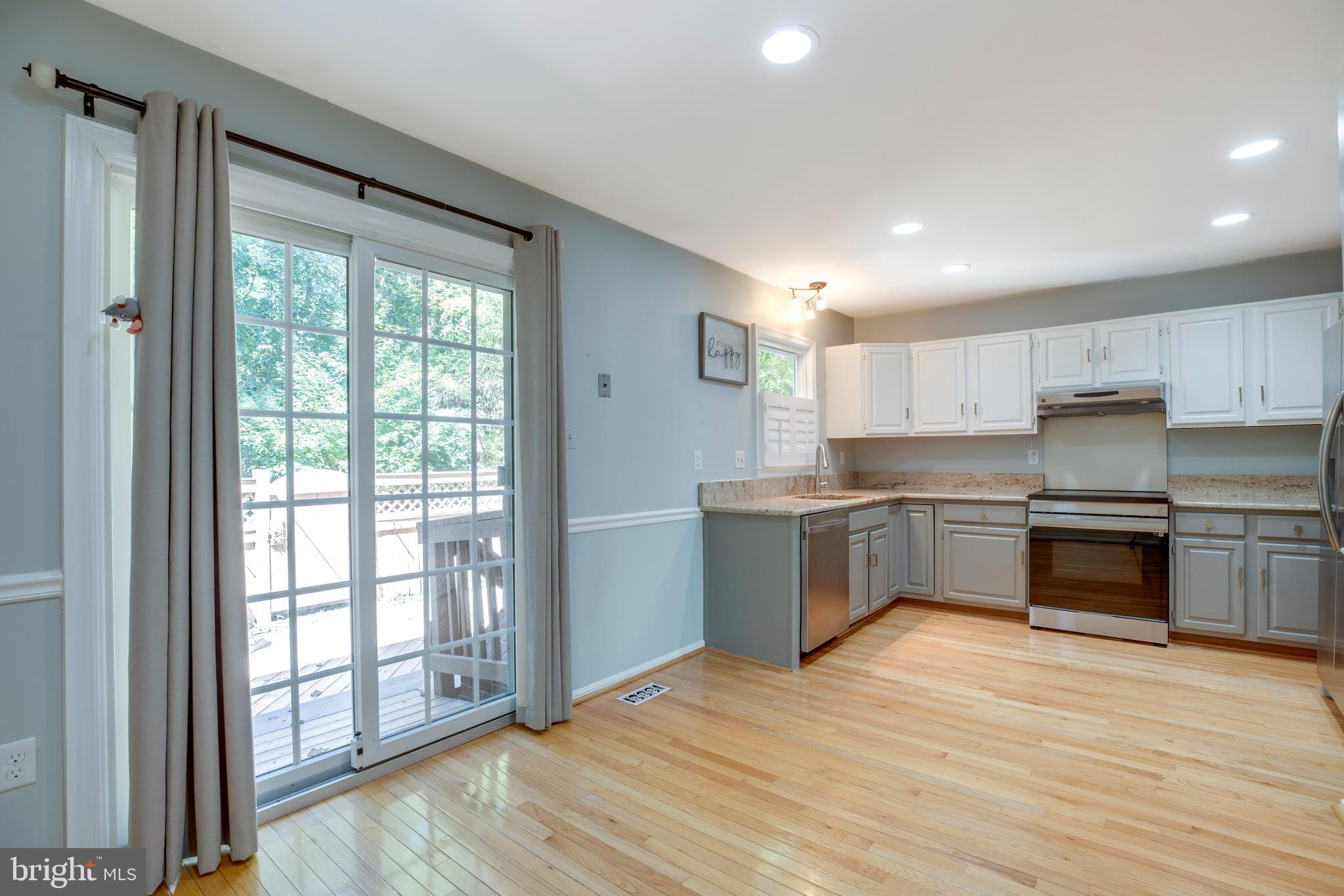 160 Washington Street Occoquan, VA 22125 - Photo 13 of 30 a kitchen with stainless steel appliances a refrigerator sink and cabinets