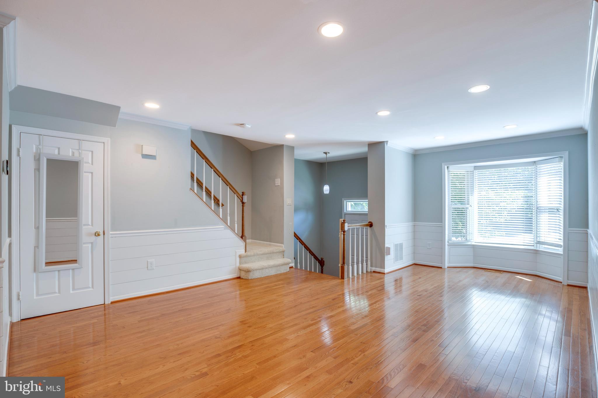 160 Washington Street Occoquan, VA 22125 - Photo 2 of 30 a view of an empty room with wooden floor and a window
