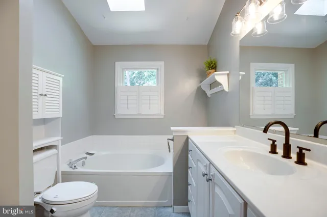 a bathroom with a double vanity sink mirror and shower
