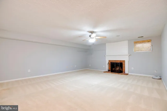 a view of a livingroom with a ceiling fan and a chandelier fan