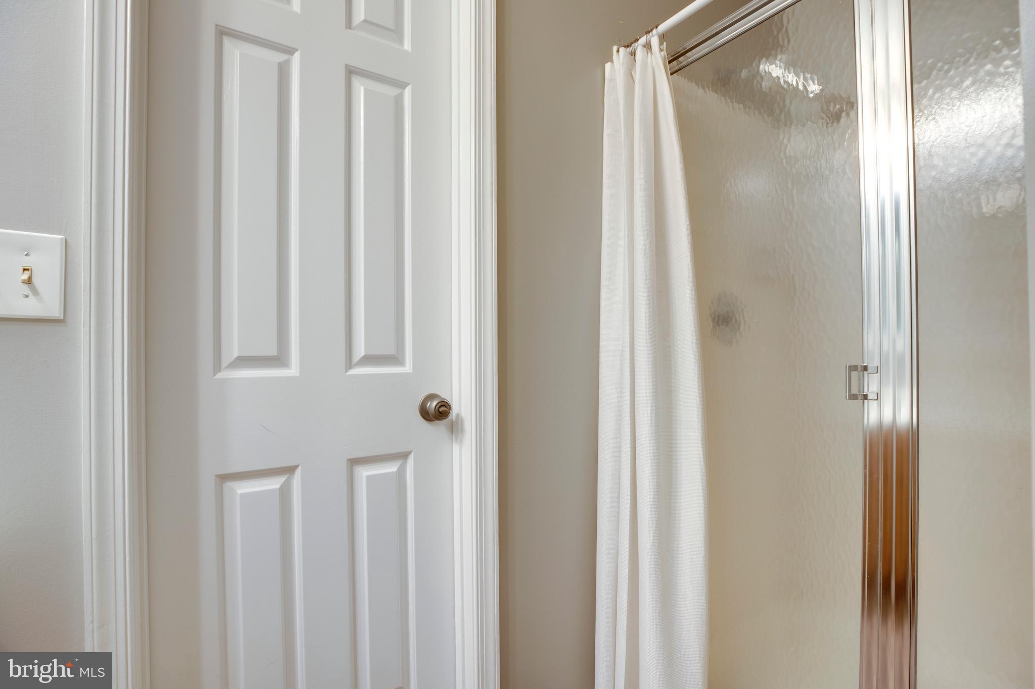 160 Washington Street Occoquan, VA 22125 - Photo 28 of 30 a bathroom with a glass shower door and a sink