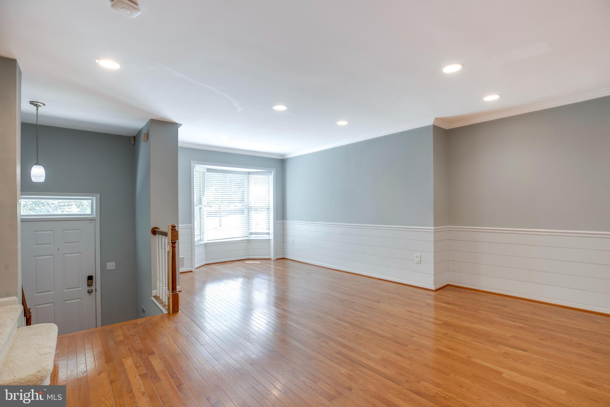 160 Washington Street Occoquan, VA 22125 - Photo 5 of 30 a view of an empty room with wooden floor and a window