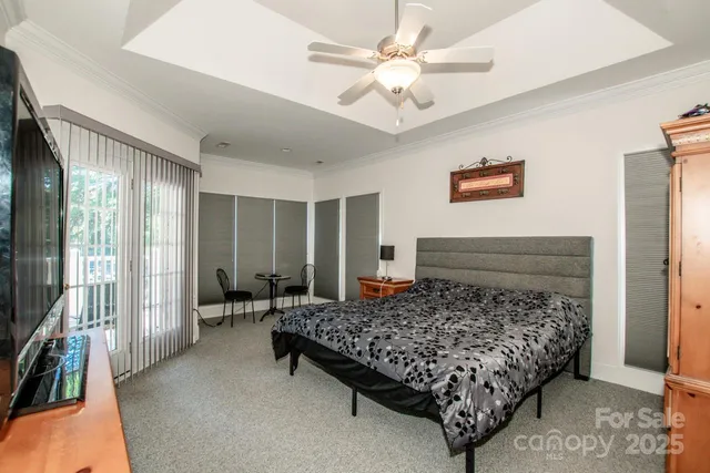 a bedroom with a bed and a chandelier