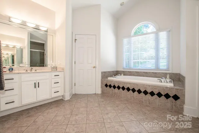 a large spacious bathroom with a tub and a large window