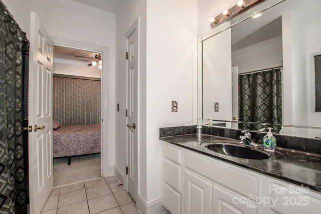 a en suite bathroom with a sink a mirror and a bathtub