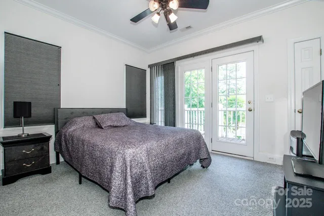 a spacious bedroom with a bed and a chandelier