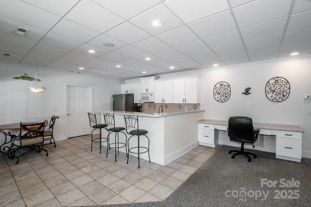 a view of a kitchen with kitchen island granite countertop lots of counter top space
