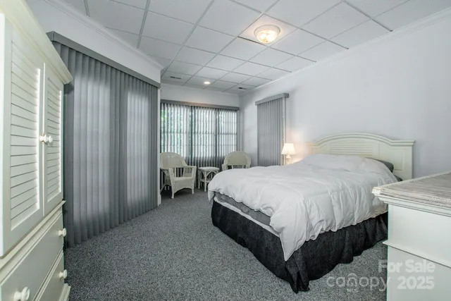 a spacious bedroom with a bed and a large window