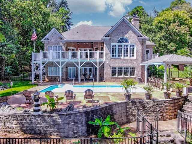 a view of a house with swimming pool and a yard