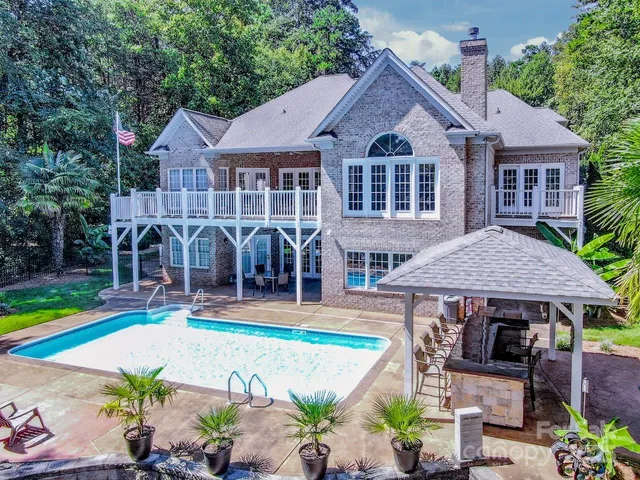 an aerial view of a house with swimming pool