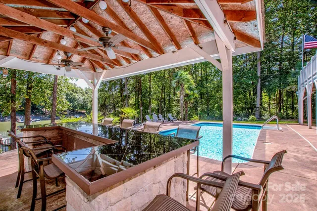 a patio with yard glass top table and chairs