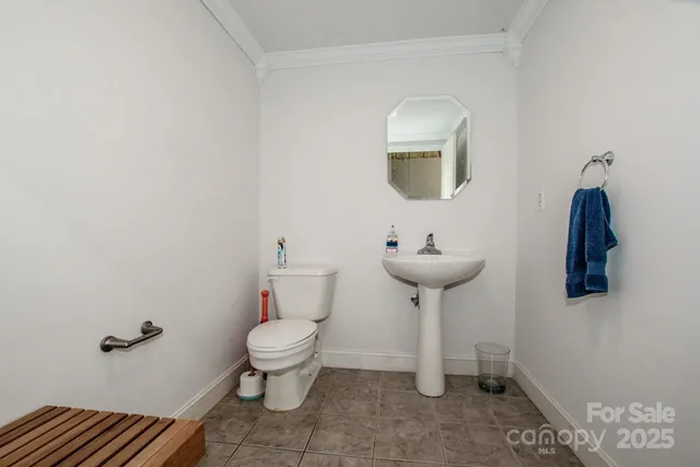 a bathroom with a toilet a sink and a mirror