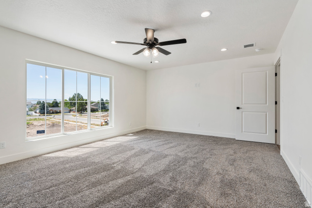504 North 650 E Street Springville, UT 84663 - Photo 14 of 36 Spacious interior featuring a large multi-pane window, recessed lighting, and a ceiling fan with integrated lighting