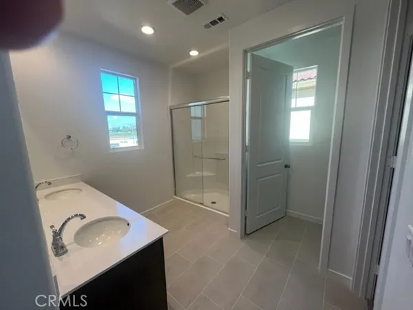a bathroom with a sink vanity granite tub and shower