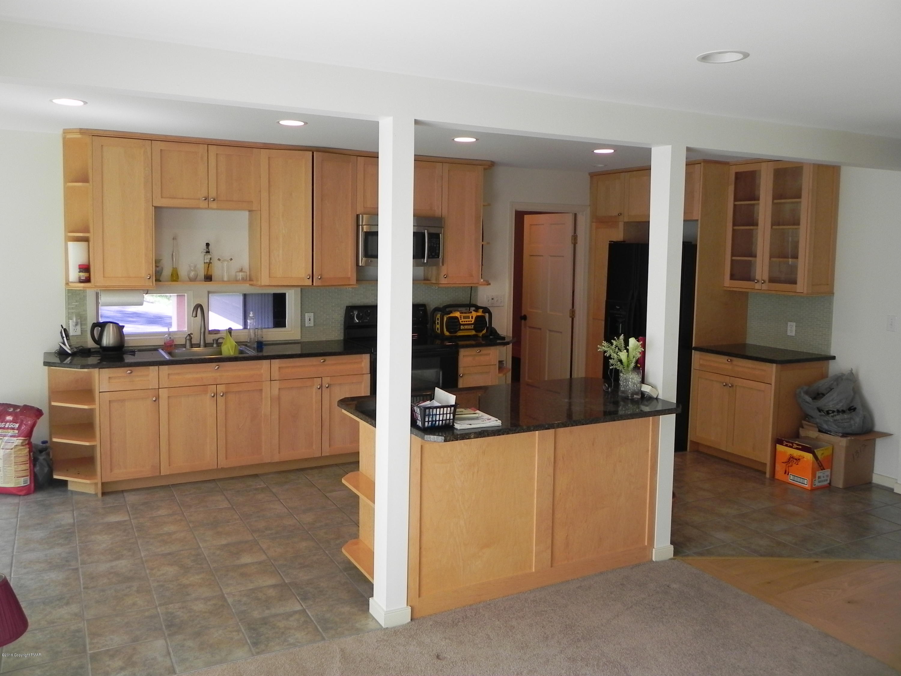2342 Point Phillips Road Kunkletown, PA 18058 - Photo 7 of 28 a kitchen with stainless steel appliances kitchen island granite countertop a refrigerator and cabinets