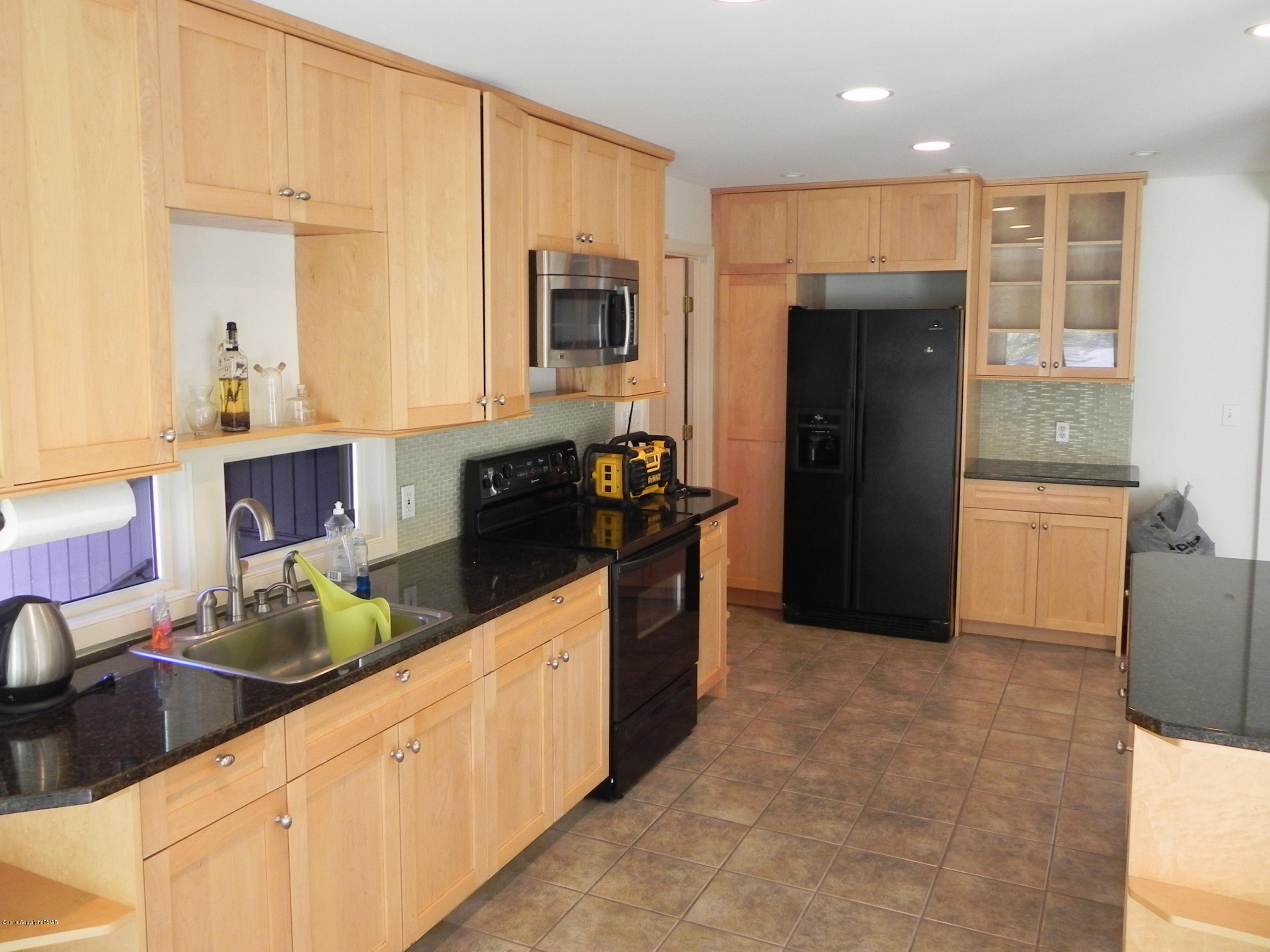 2342 Point Phillips Road Kunkletown, PA 18058 - Photo 8 of 28 a kitchen with stainless steel appliances kitchen island granite countertop a refrigerator and a sink