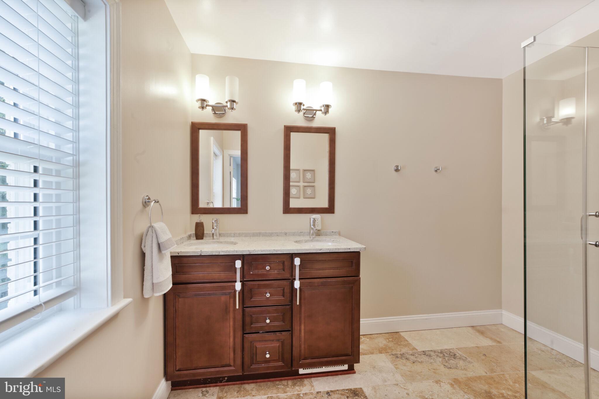 1512 Live Oak Drive Silver Spring, MD 20910 - Photo 20 of 34 a spacious bathroom with a granite countertop sink a mirror and a