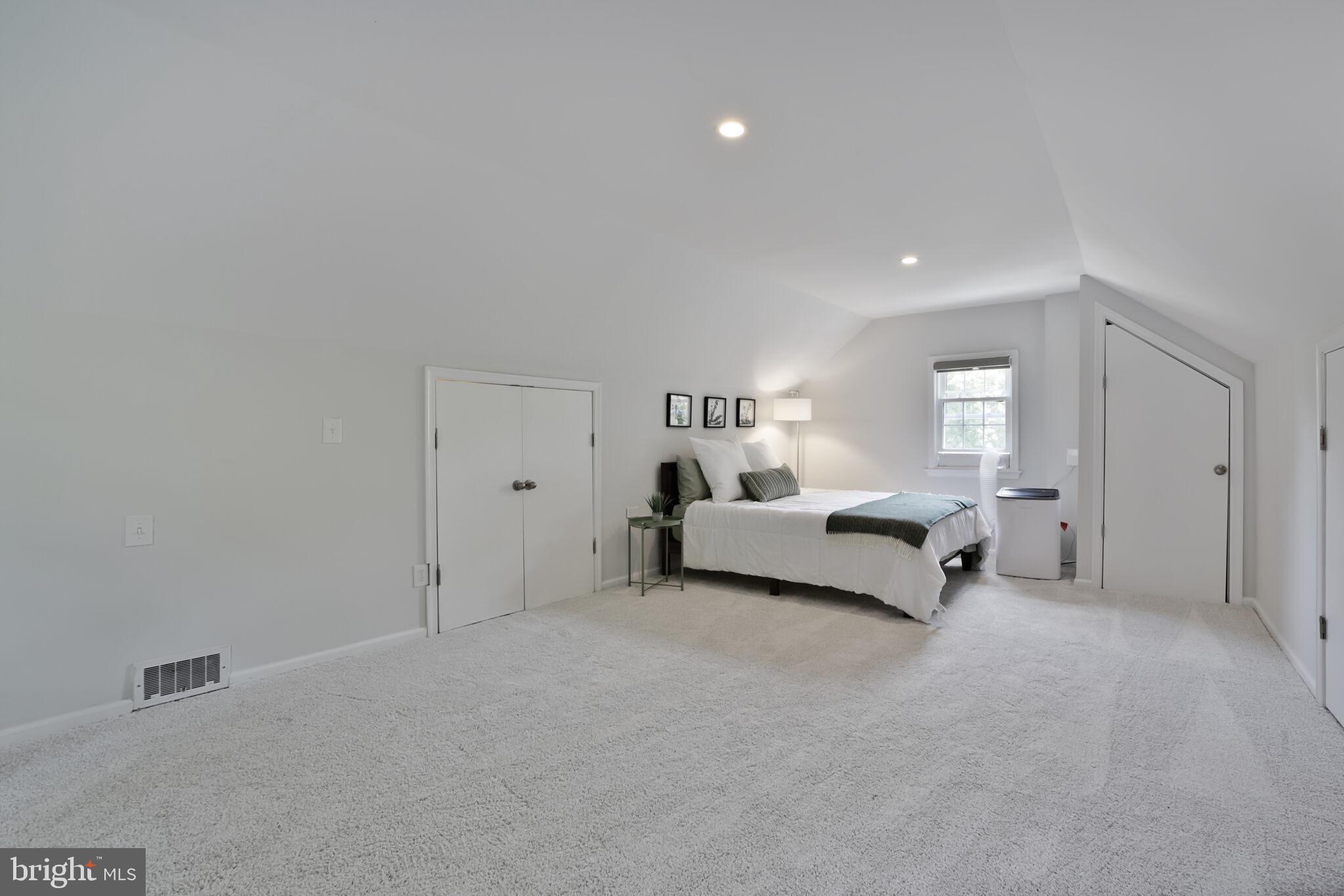 1512 Live Oak Drive Silver Spring, MD 20910 - Photo 24 of 34 a spacious bedroom with a bed and a couch