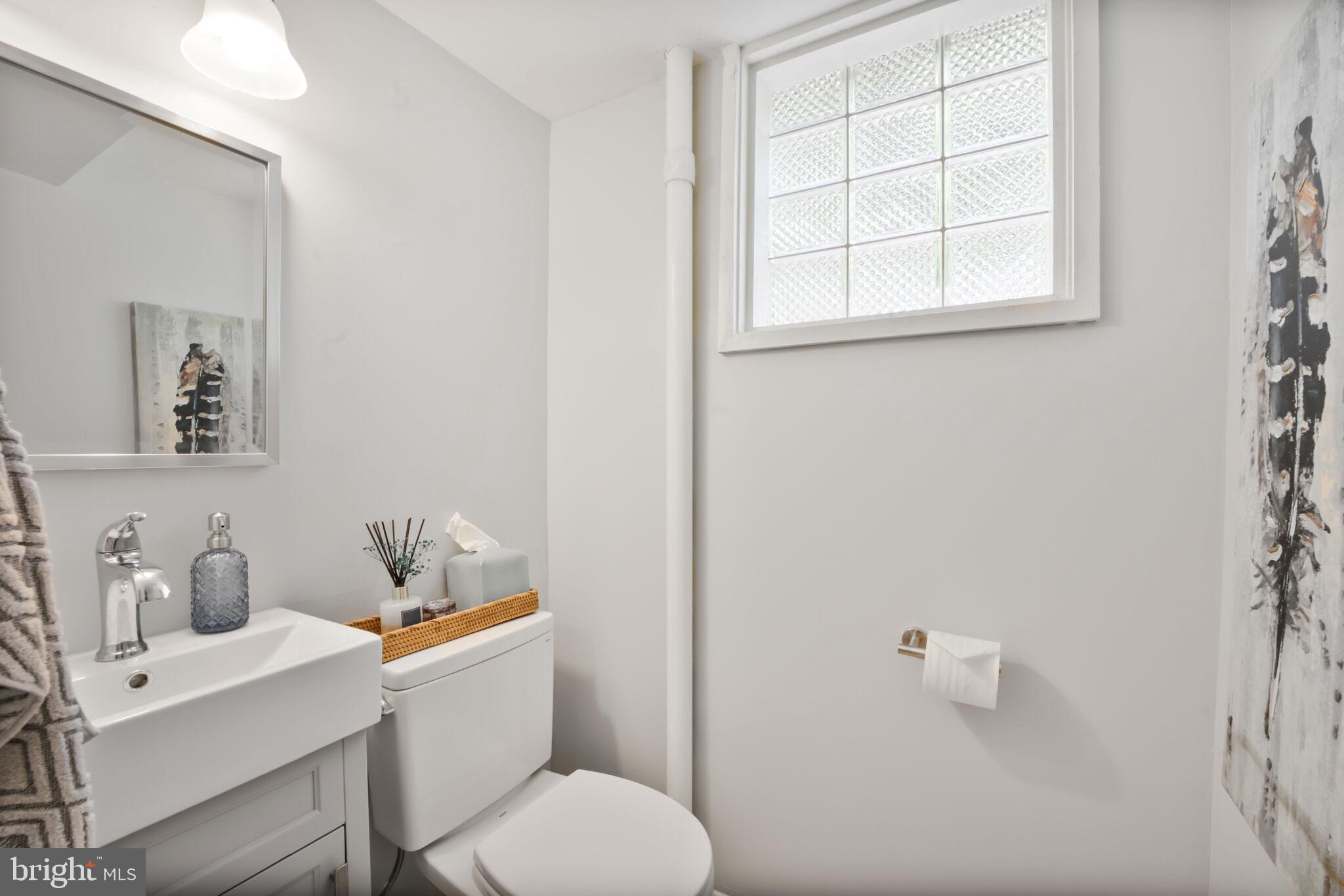 1512 Live Oak Drive Silver Spring, MD 20910 - Photo 27 of 34 a white toilet sitting next to a bathroom sink