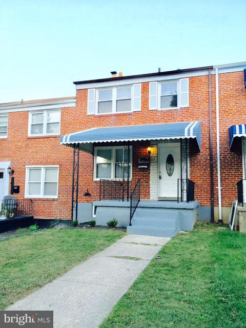 6023 Falkirk Road Baltimore, MD 21239 - Photo 2 of 20 a front view of a house with a yard and garage