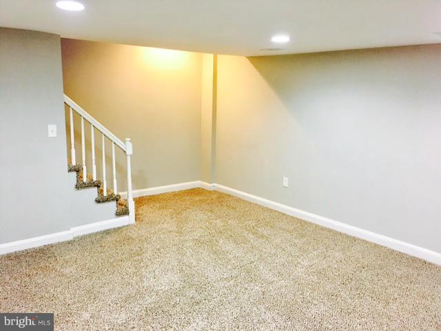 6023 Falkirk Road Baltimore, MD 21239 - Photo 15 of 20 a view of an empty room with wooden floor