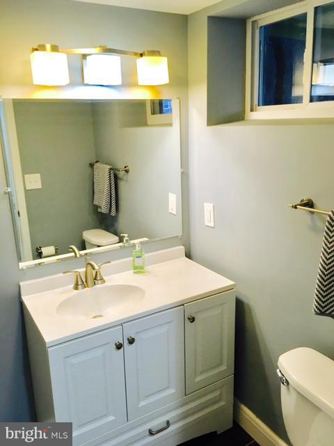 6023 Falkirk Road Baltimore, MD 21239 - Photo 16 of 20 a bathroom with a sink toilet and a mirror