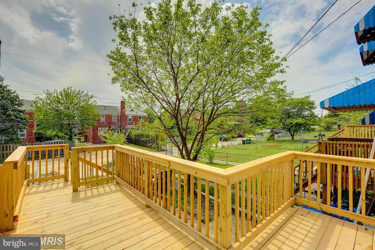 6023 Falkirk Road Baltimore, MD 21239 - Photo 20 of 20 a view of a balcony with two large trees