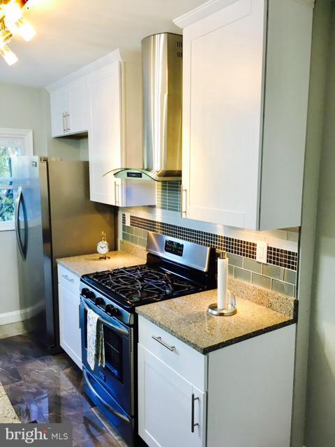 6023 Falkirk Road Baltimore, MD 21239 - Photo 3 of 20 a kitchen with granite countertop a sink stove and refrigerator