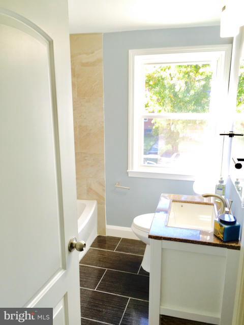 6023 Falkirk Road Baltimore, MD 21239 - Photo 9 of 20 a bathroom with a sink and a mirror