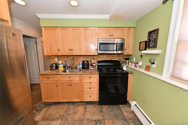 a kitchen with stainless steel appliances granite countertop a refrigerator stove and sink