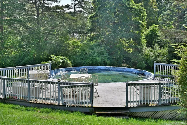 a view of a deck and yard with green space