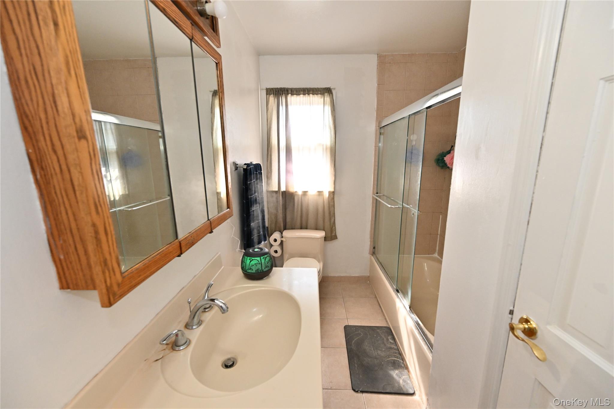 41 Harkin Road Carmel, NY 10512 - Photo 6 of 20 a bathroom with a sink a mirror and a shower