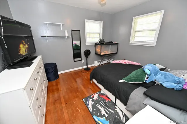 a bedroom with a bed and flat screen tv