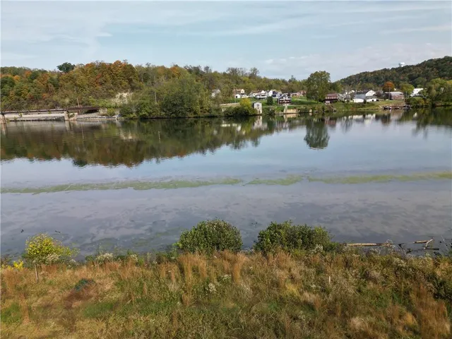 a view of a lake with houses in the back