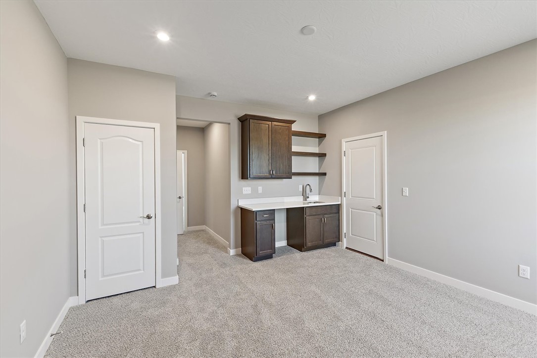 407 South Landon Lane Springfield, OH 45502 - Photo 15 of 30 This versatile room features a wet bar with cabinetry, offering flexible living possibilities.