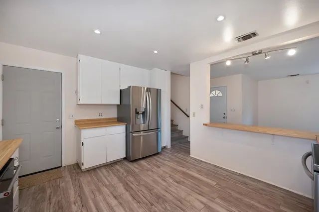 a kitchen with stainless steel appliances a refrigerator and a stove top oven