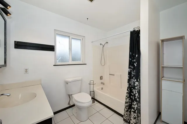 a bathroom with a toilet a sink and shower