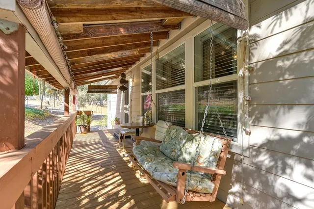 a view of a patio with table and chairs and wooden floor