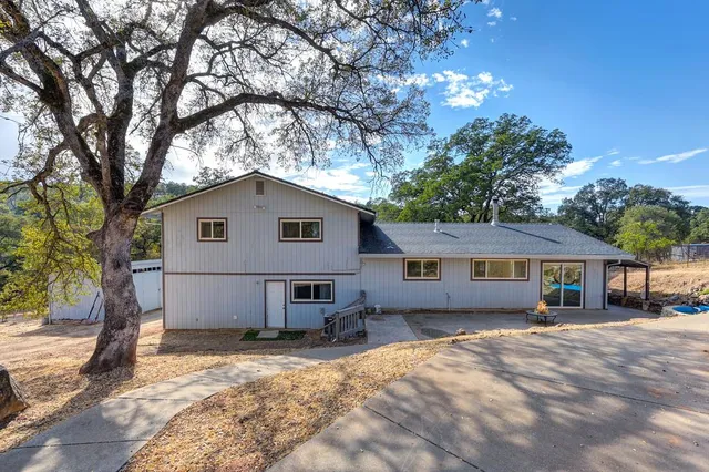 a view of a house with a yard covered in snow