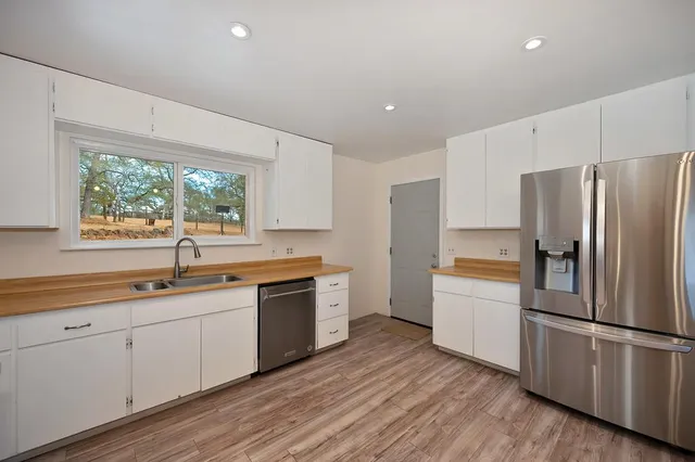 a kitchen with a refrigerator and a sink