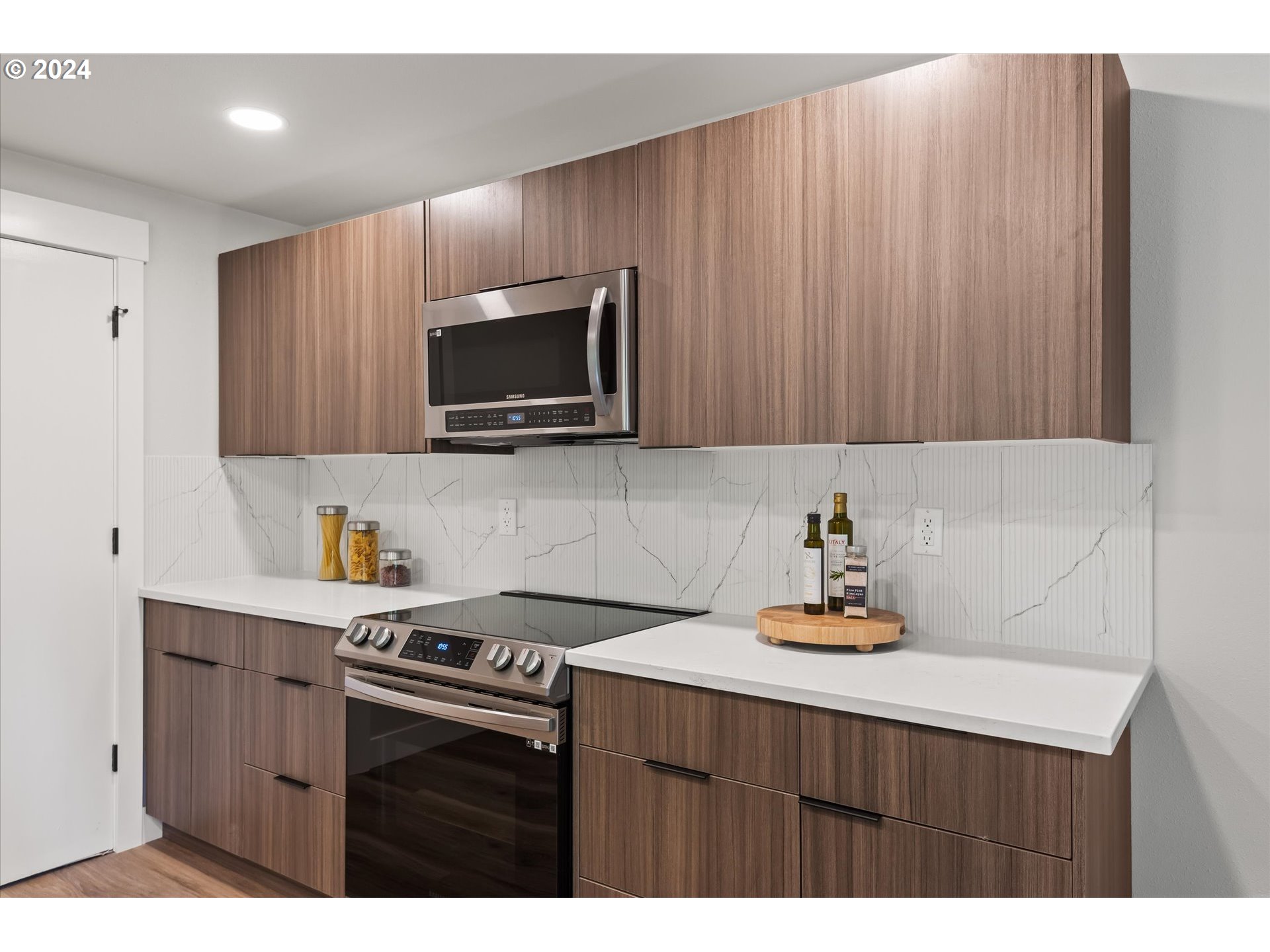 70 Coachman Drive Eugene, OR 97405 - Photo 11 of 43 a kitchen with a sink dishwasher stove and microwave with wooden cabinets