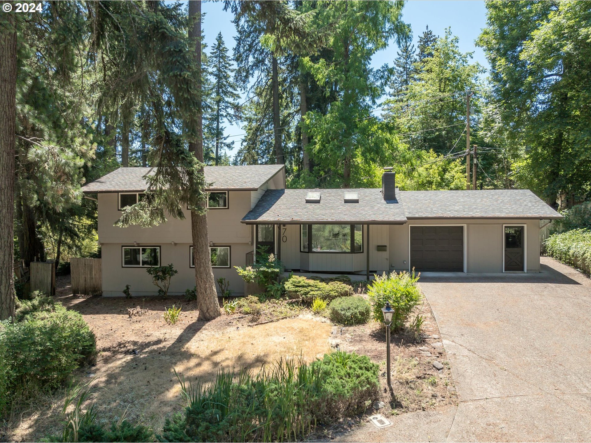 70 Coachman Drive Eugene, OR 97405 - Photo 38 of 43 a front view of a house with a yard and garage