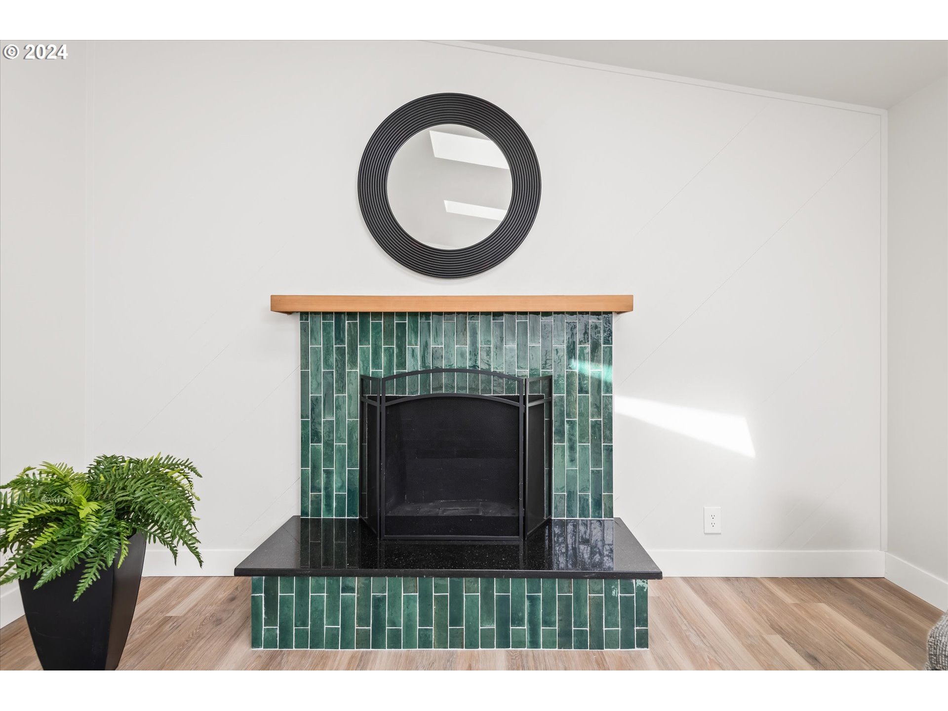 70 Coachman Drive Eugene, OR 97405 - Photo 8 of 43 a living room with a fireplace and a potted plant