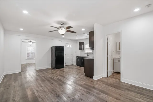 a view of a kitchen with a sink and a refrigerator