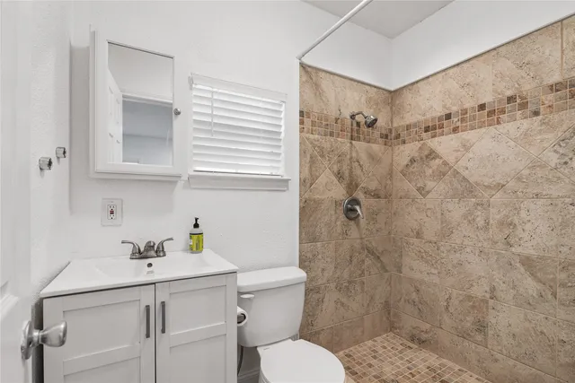 a bathroom with a sink toilet and shower