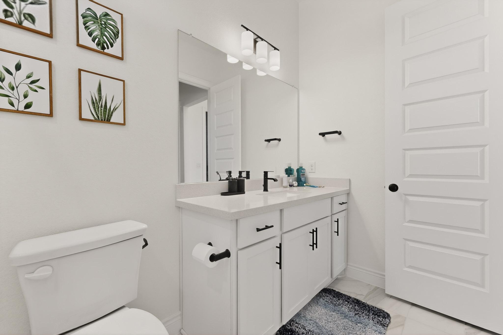 2121 Lolo Lane Leander, TX 78641 - Photo 17 of 26 Bathroom featuring vanity and light marble finish floors